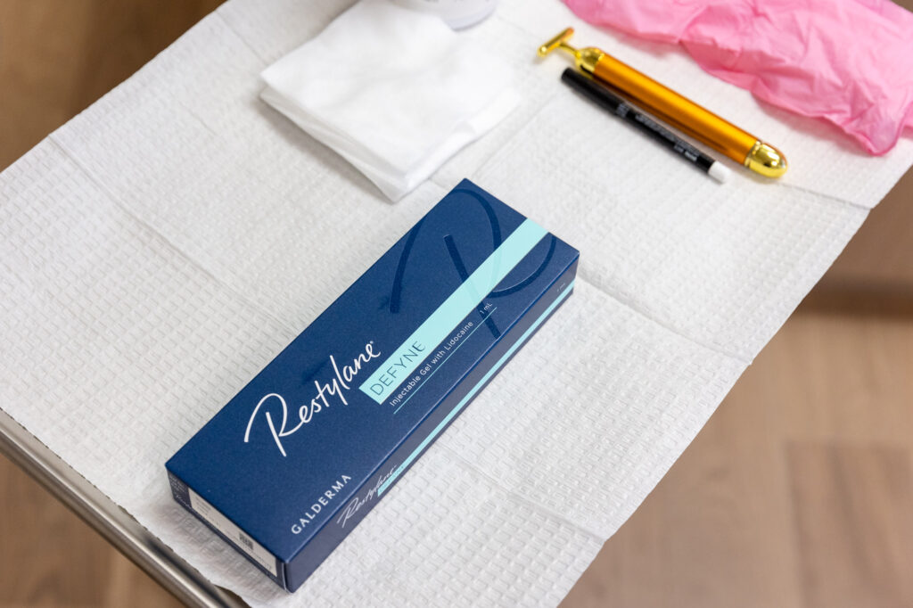 Box of Restylane sitting neatly on a towel next to pads, and other tools to administer Botox and Fillers in Las Vegas.
