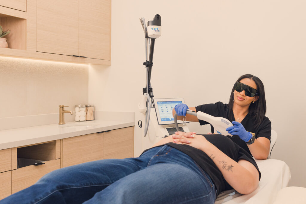 Provider wearing sunglasses places the BBL HERO device onto the Guest's face. This is part of a series of sessions for laser hair removal near Centennial Hills at Archway Aesthetics.
