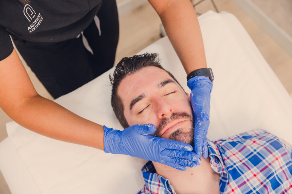 A male patient receives a soothing custom facial with us at our med spa near Henderson.