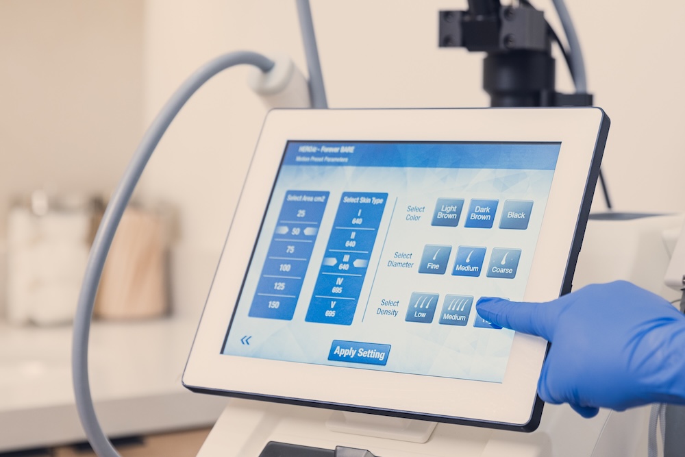 A provider at Archway Aesthetics, a laser hair removal clinic in Las Vegas, helps a patient prepare for their laser hair removal treatment sessions.